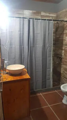 a bathroom with a sink and a shower at Alojamiento Tanti in Villa Santa Cruz del Lago