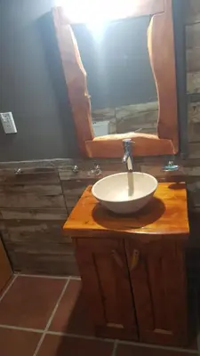 a bathroom with a sink and a mirror at Alojamiento Tanti in Villa Santa Cruz del Lago