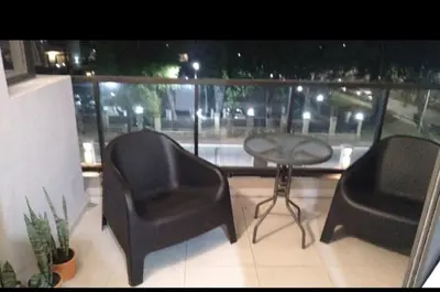 a balcony with two chairs and a table and a table and chairs at Costanera Park in Cordoba