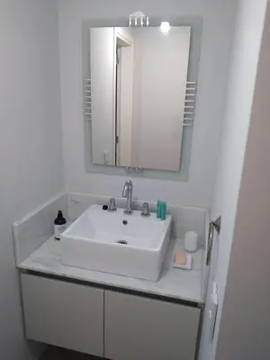 a bathroom with a white sink and a mirror at Costanera Park in Cordoba