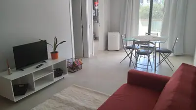a living room with a red couch and a table at Costanera Park in Cordoba