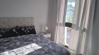 a bedroom with a bed next to a window at Costanera Park in Cordoba
