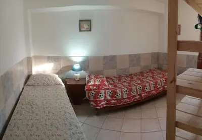 a room with two beds and a table with a lamp at El central in Tanti