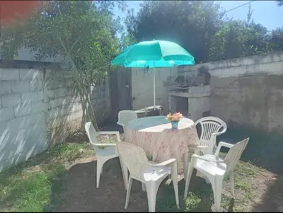a table with chairs and an umbrella on a patio at El central in Tanti
