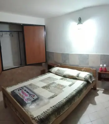 a bedroom with a bed in a room with a light at El central in Tanti
