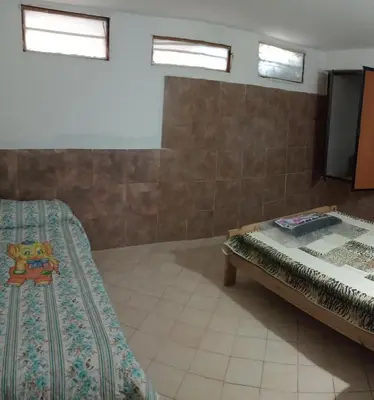 a room with a bed and a tv in it at El central in Tanti