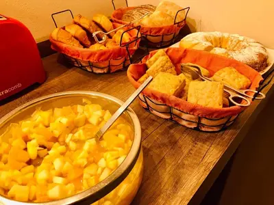 a group of bowls of food on a wooden table at Cortaderas Hotel de Campo Nono in Nono