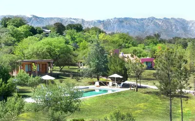 a villa with a swimming pool and a resort at Cortaderas Hotel de Campo Nono in Nono