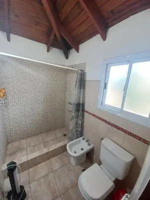 a bathroom with a toilet and a sink at Tantanakuy in Villa General Belgrano