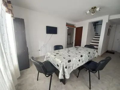 a dining room table and chairs in a room at Tantanakuy in Villa General Belgrano