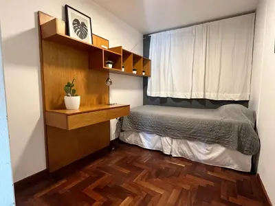 a small bedroom with a bed and a window at Departamento Chacabuco in Cordoba