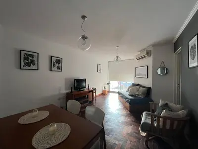a living room with a table and a couch at Departamento Chacabuco in Cordoba