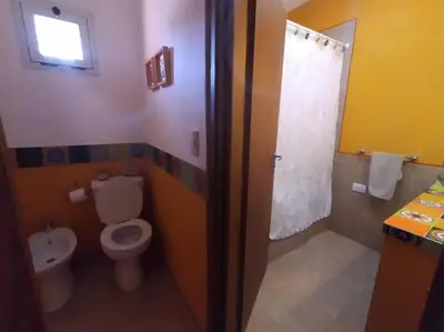 a bathroom with a toilet and a shower and a sink at Comodidad y espacio para relax in Falda del Carmen