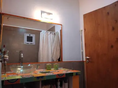 a bathroom with a sink and a large mirror at Comodidad y espacio para relax in Falda del Carmen