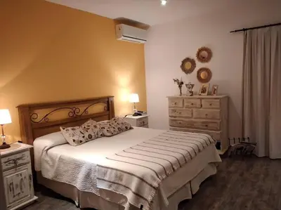 a bedroom with a large bed and two dressers at Comodidad y espacio para relax in Falda del Carmen