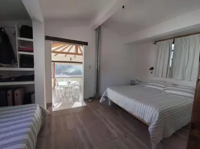 a bedroom with two beds and a large window at Cabaña a Arroyo Cristal in Tanti