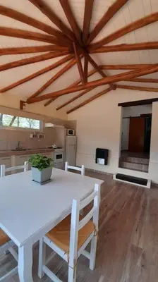 a dining room with a white table and chairs at Cabaña a Arroyo Cristal in Tanti