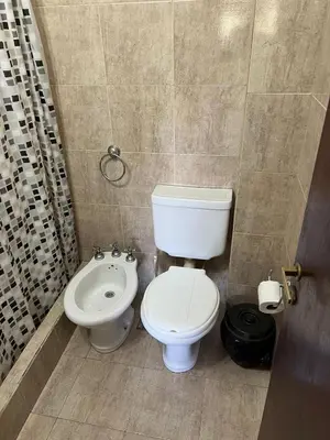 a bathroom with a toilet and a bidet at La Loma Resort in Merlo