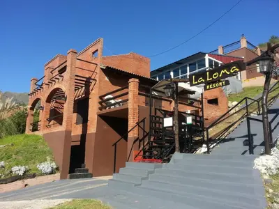 a brick building with stairs leading up to it at La Loma Resort in Merlo