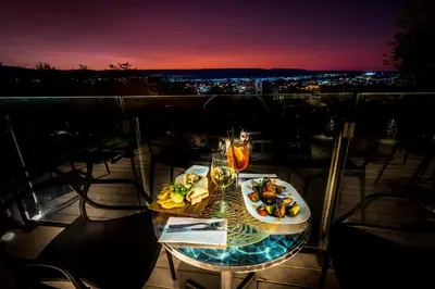 a table with a plate of food on a balcony at Pinares Panorama Suites, Spa & Convention Center in Villa Carlos Paz