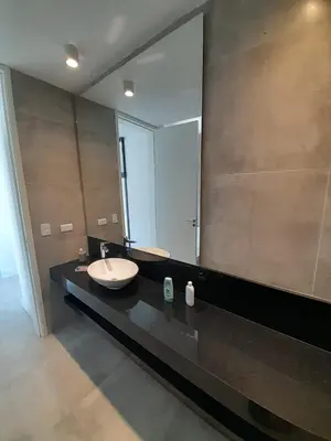 a bathroom with a sink and a large mirror at Hermosa casa en Puerto del Águila, a orillas del Dique Los Molinos in La Estancia
