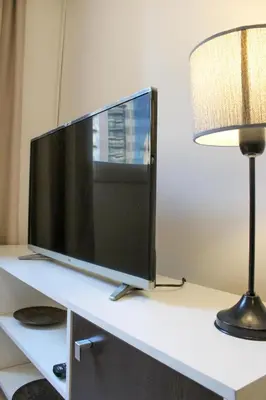 a computer monitor on a desk next to a lamp at THAYS 70. Hermoso Dpto en Parque de Las Tejas in Cordoba