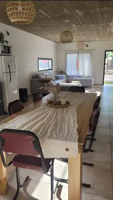 a large wooden table in a room with a living room at Casa Buda in Almafuerte