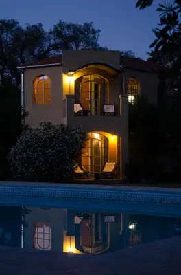 a house with a pool in front of it at night at Las Nubes Apart in Merlo