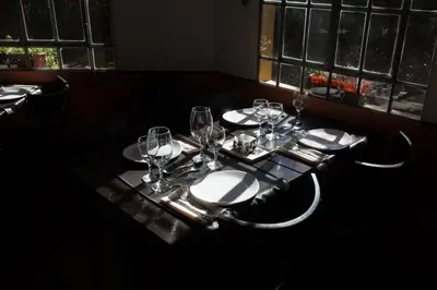 a table with wine glasses and plates on it at Las Nubes Apart in Merlo