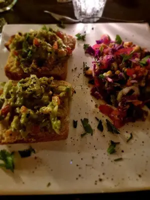 two slices of pizza on a white plate at Las Nubes Apart in Merlo