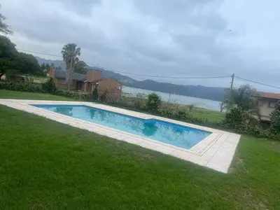 a swimming pool in the yard of a house at CASA VILLA LAGO AZUL CARLOS PAZ in Villa Carlos Paz
