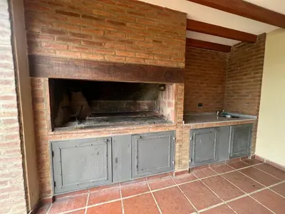 a brick wall with a fireplace in a kitchen at CASA VILLA LAGO AZUL CARLOS PAZ in Villa Carlos Paz