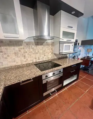 a kitchen with a stove and a microwave at CASA VILLA LAGO AZUL CARLOS PAZ in Villa Carlos Paz