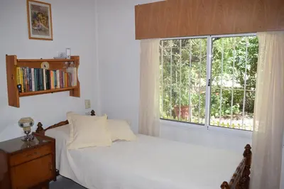 a bedroom with a bed and a large window at El sueño de Norma in San Antonio de Arredondo