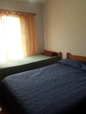 a bedroom with two beds and a window at Andresito in Santa María