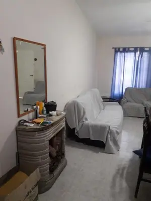 a living room with a bed and a mirror at Andresito in Santa María