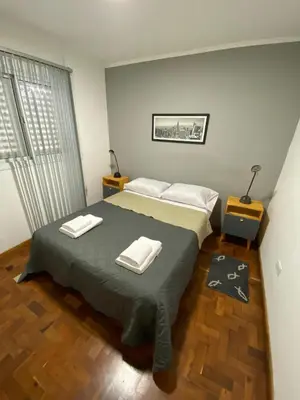 a bedroom with a bed with two towels on it at Cómodo departamento, excelente ubicacion in Cordoba