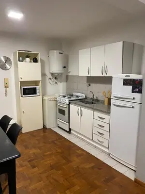 a kitchen with white appliances and white cabinets at Cómodo departamento, excelente ubicacion in Cordoba