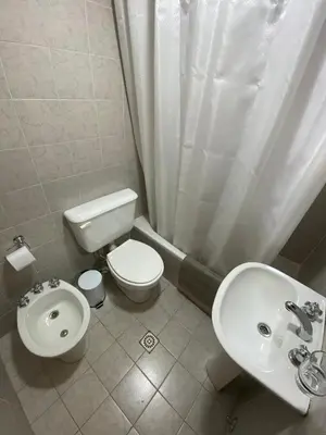 a small bathroom with a toilet and a sink at Cómodo departamento, excelente ubicacion in Cordoba