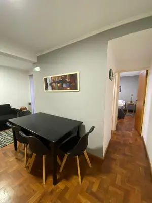 a dining room with a black table and chairs at Cómodo departamento, excelente ubicacion in Cordoba