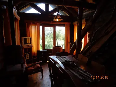 a living room with a window and a wooden floor at Cabañas El Milagro in San Roque