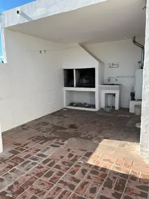 an empty living room with a fireplace and a tv at Departamento Balneario (Centro) in Villa Dolores