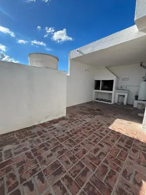 a brick patio with a fireplace on a building at Departamento Balneario (Centro) in Villa Dolores