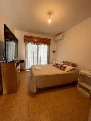 a bedroom with a bed and a flat screen tv at Departamento Balneario (Centro) in Villa Dolores