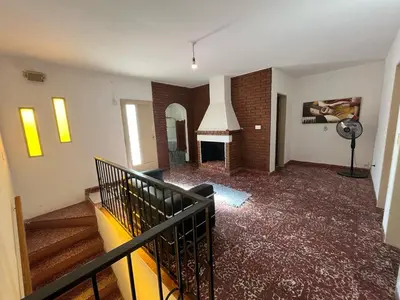 an empty room with a staircase and a fireplace at Departamento Balneario (Centro) in Villa Dolores