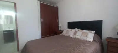 a bedroom with a bed with pillows and a mirror at La Delia in Villa Cura Brochero