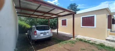 a car parked under a carport next to a house at La Delia in Villa Cura Brochero