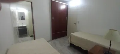 a bedroom with a bed and a door with a mirror at La Delia in Villa Cura Brochero