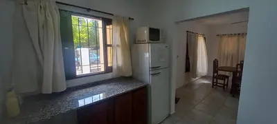a kitchen with a refrigerator and a window at La Delia in Villa Cura Brochero