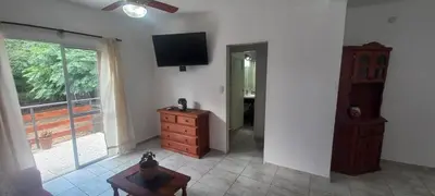a living room with a dresser and a television on the wall at La Delia in Villa Cura Brochero